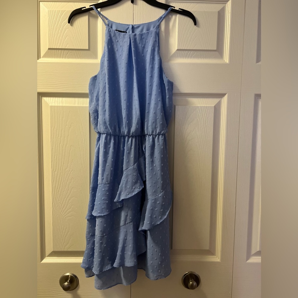 A chic sleeveless mini dress in a blue shade, perfect for any special occasion.